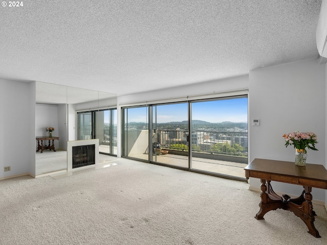 living room with carpet, baseboards, and a textured ceiling