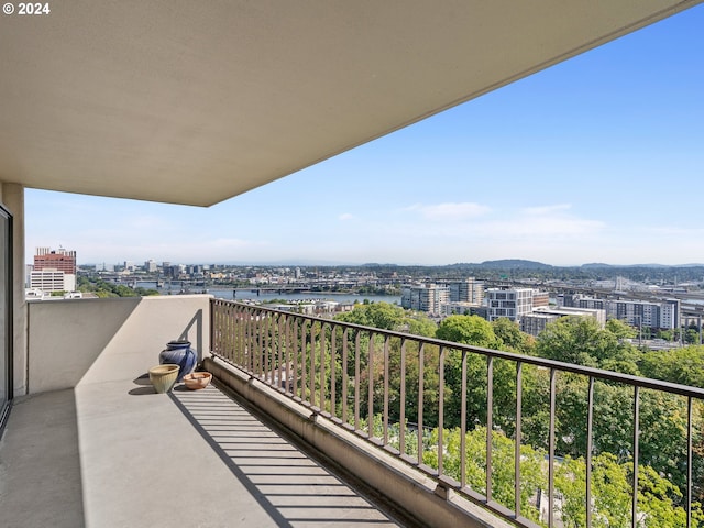 balcony featuring a view of city and a water view