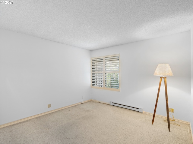 carpeted empty room featuring baseboards, a textured ceiling, and baseboard heating