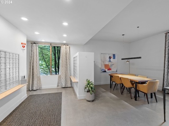 dining area featuring finished concrete floors, recessed lighting, baseboards, and mail area