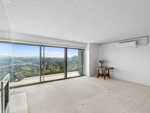 unfurnished room featuring a textured ceiling, carpet floors, a wall mounted AC, and baseboards