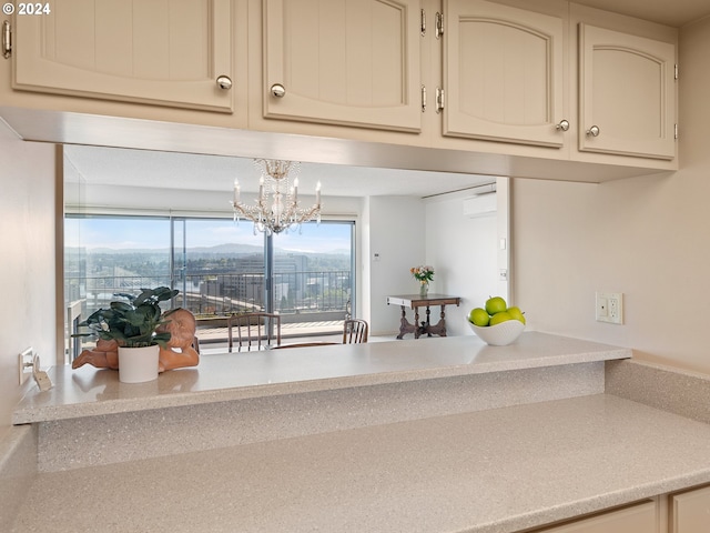 interior space featuring cream cabinets, light countertops, and a notable chandelier