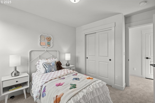 bedroom with light colored carpet and a closet