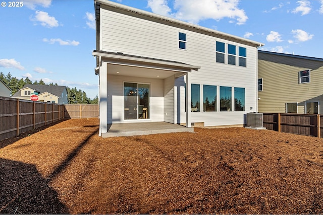 rear view of property featuring central air condition unit and a patio