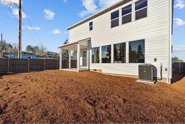 back of house featuring central AC unit