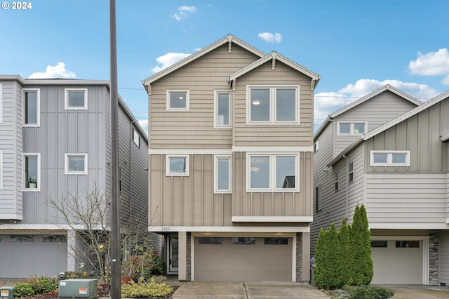 view of front of property featuring central air condition unit and a garage