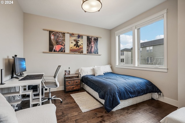 bedroom with dark hardwood / wood-style floors