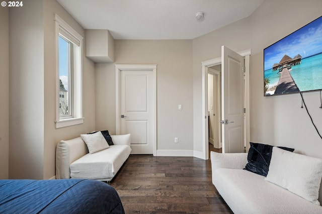 bedroom with dark hardwood / wood-style flooring