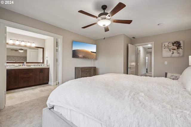 bedroom with light colored carpet, ceiling fan, and ensuite bathroom