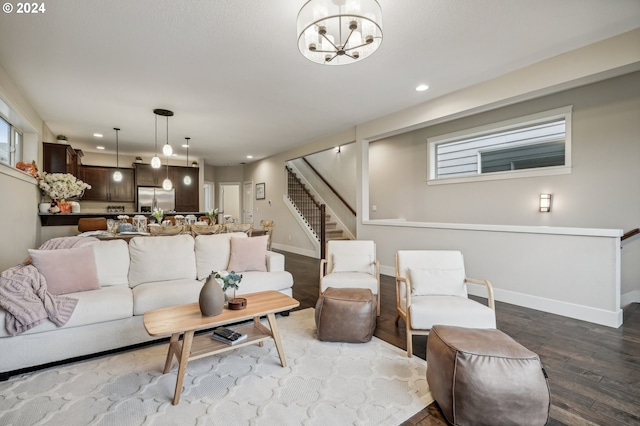 living room featuring hardwood / wood-style floors and a notable chandelier