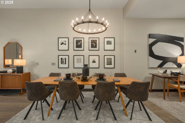 dining area with wood finished floors and a notable chandelier