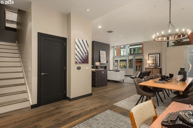 dining room featuring dark wood-style floors, visible vents, stairway, an inviting chandelier, and baseboards