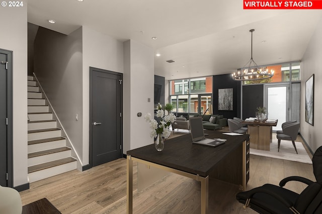 office space featuring a notable chandelier and light wood-type flooring