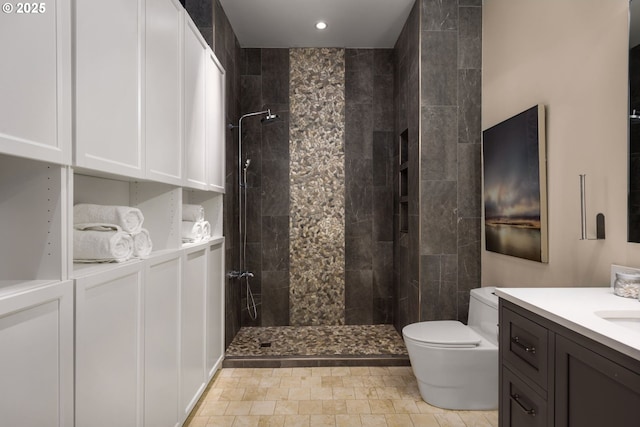 bathroom featuring vanity, toilet, and walk in shower