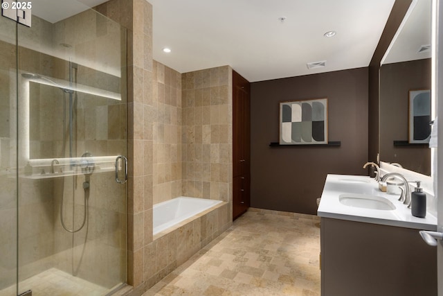 full bathroom with double vanity, a stall shower, visible vents, a sink, and a bath