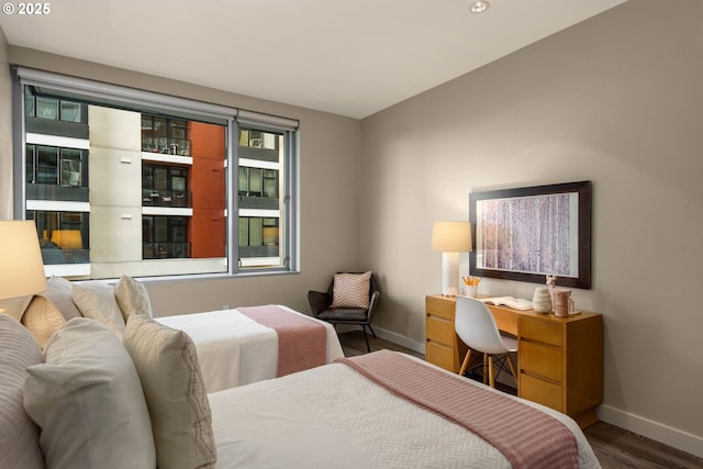 bedroom featuring baseboards and wood finished floors