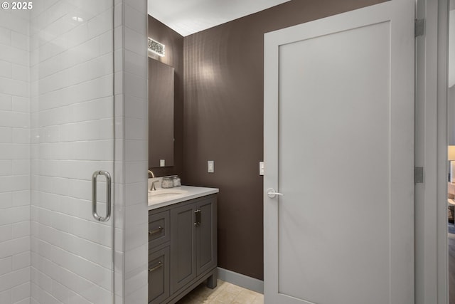 full bath with a stall shower, visible vents, baseboards, and vanity