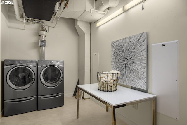 clothes washing area featuring laundry area and separate washer and dryer