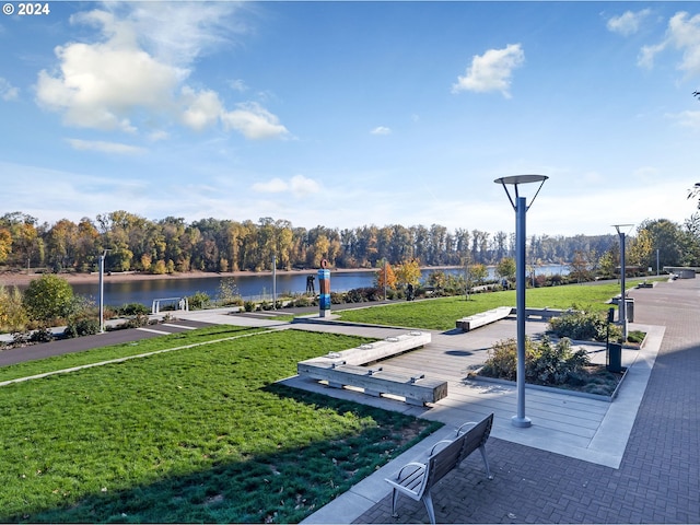 view of property's community featuring a water view and a lawn