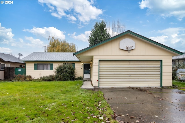 single story home featuring a garage and a front lawn