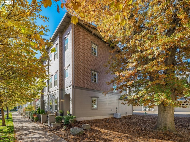 view of side of home with central AC