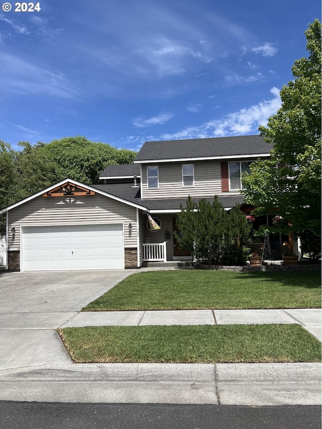 view of front of home with a garage and a front lawn