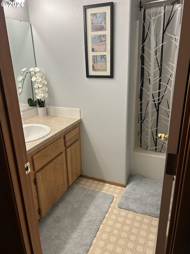 bathroom with shower / bath combo and vanity