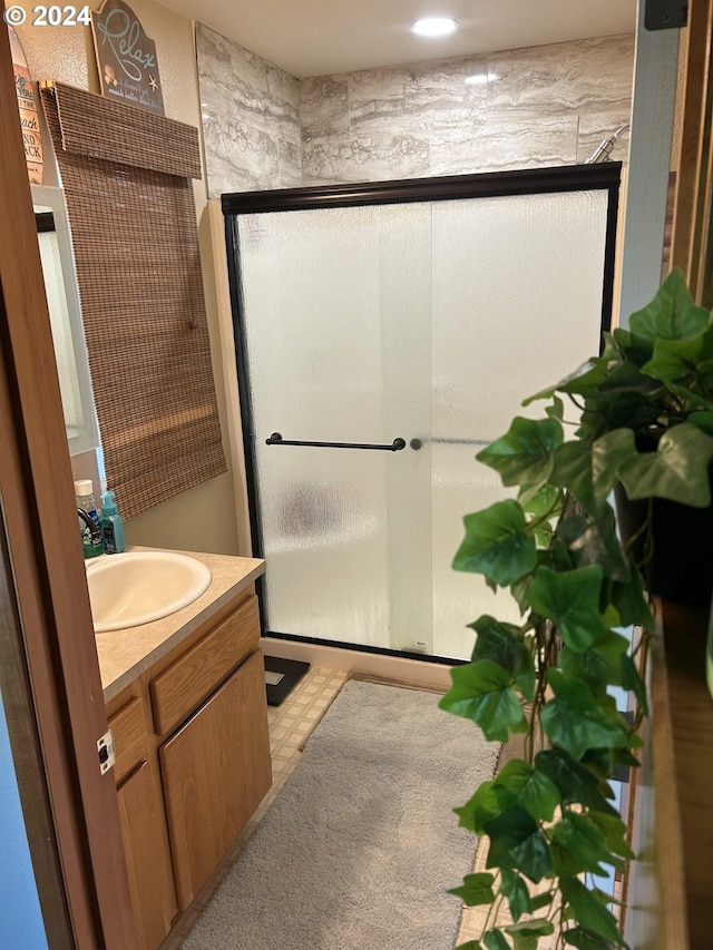 bathroom with walk in shower and vanity