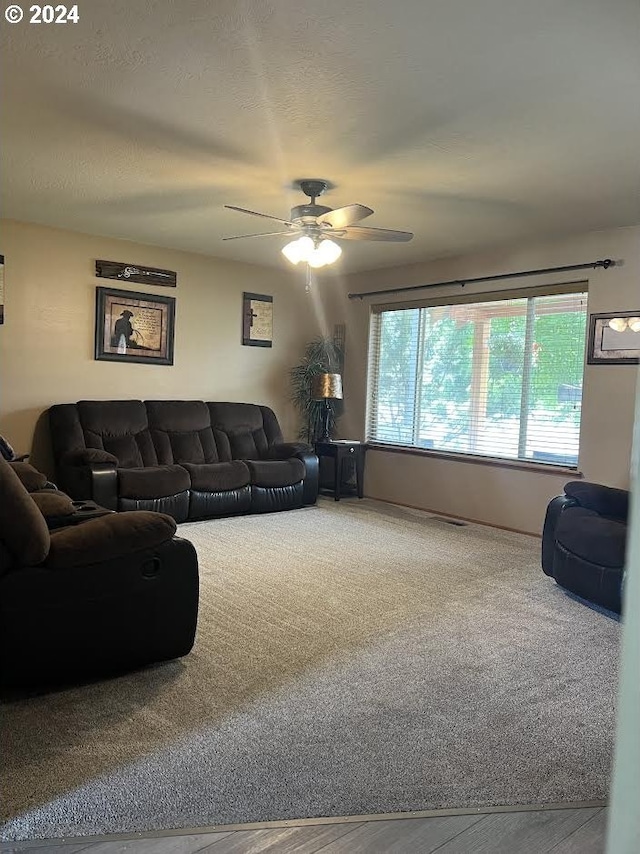 living room with carpet flooring and ceiling fan