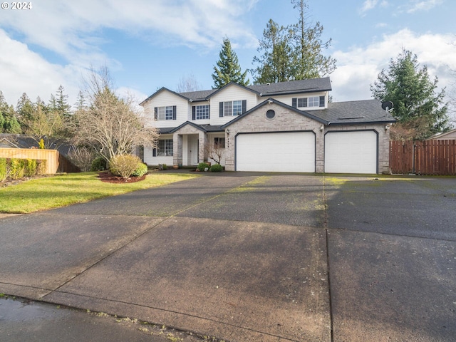 front facade with a garage and a front yard