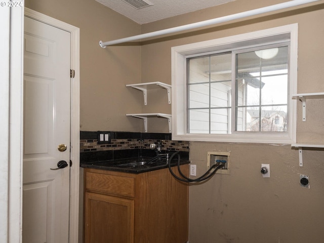 laundry room featuring washer hookup, electric dryer hookup, and sink