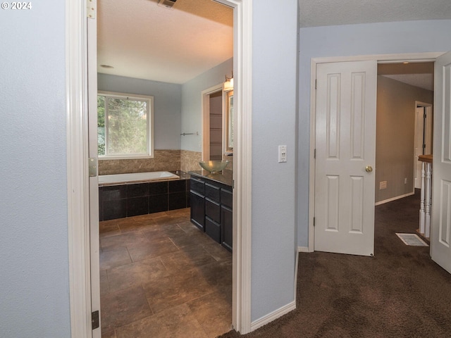 bathroom featuring tiled bath