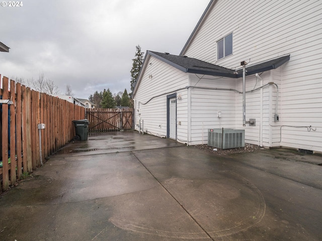 view of side of home featuring central AC unit and a patio area