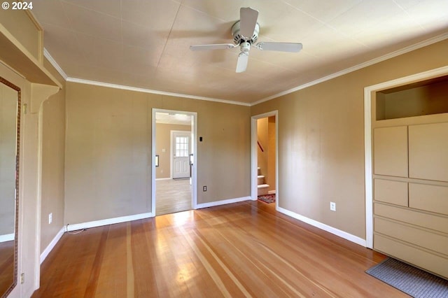 unfurnished bedroom with light wood-type flooring, ceiling fan, connected bathroom, and crown molding