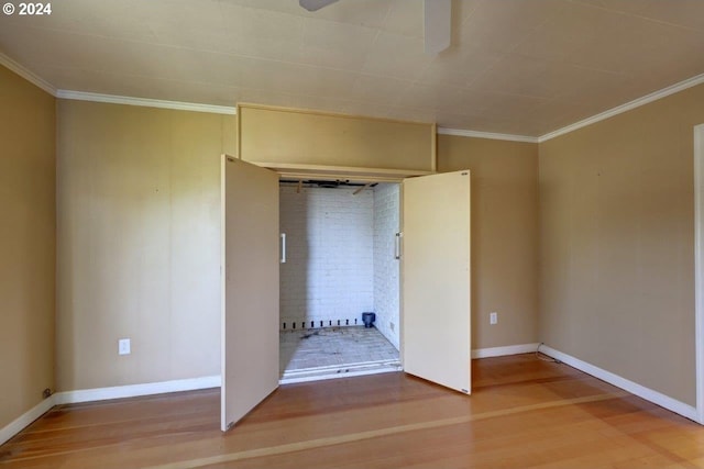 unfurnished bedroom with hardwood / wood-style floors and ornamental molding