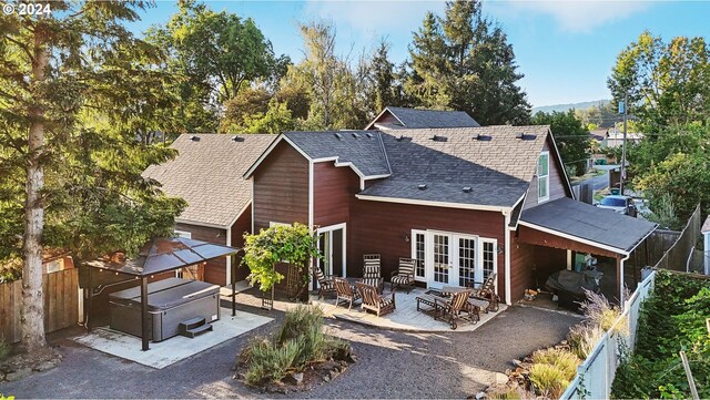 rear view of property featuring french doors and a patio