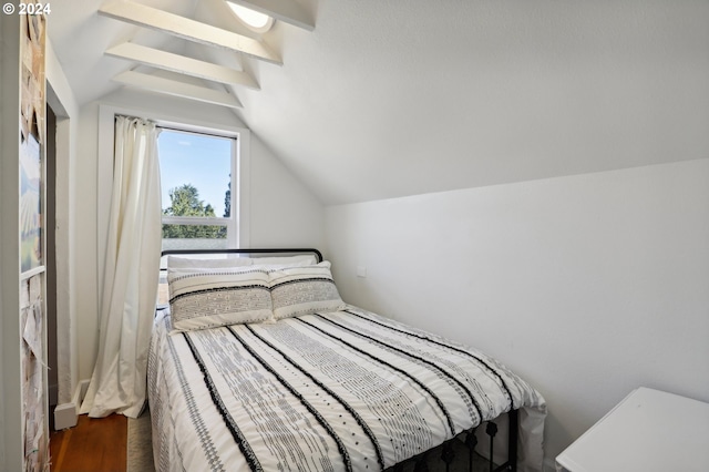 bedroom featuring lofted ceiling and dark hardwood / wood-style flooring