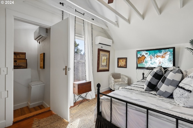 bedroom with vaulted ceiling, an AC wall unit, and hardwood / wood-style flooring