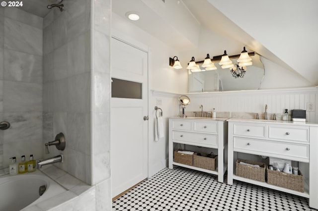 bathroom featuring tiled shower / bath and vanity