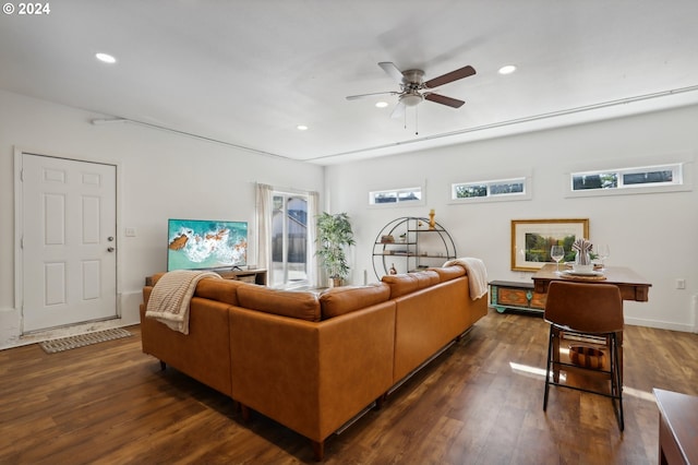 living room with a healthy amount of sunlight, ceiling fan, and dark hardwood / wood-style floors