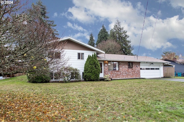 split level home with a front yard and a garage