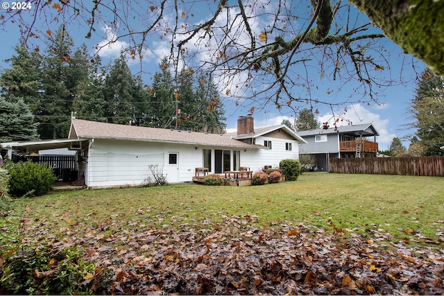 rear view of house featuring a lawn