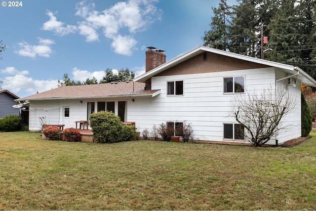 rear view of property featuring a yard