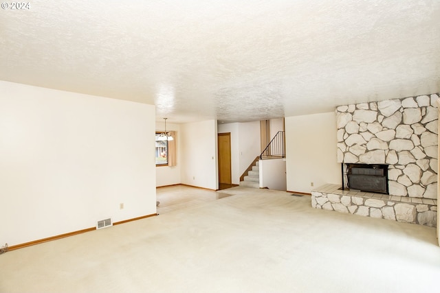 unfurnished living room with carpet, a fireplace, and a textured ceiling