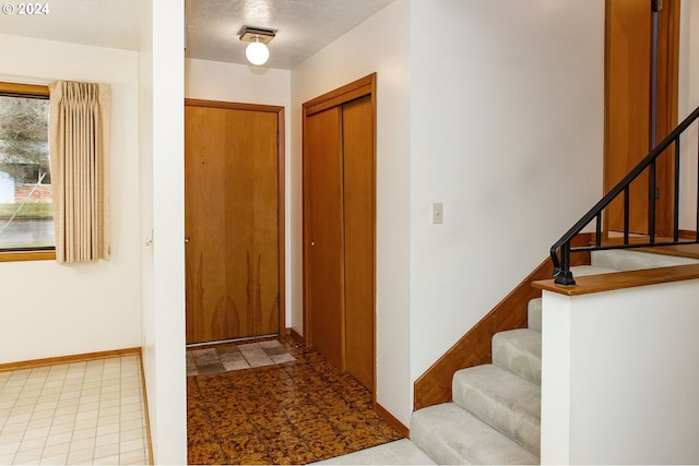 foyer featuring a textured ceiling