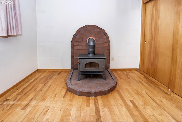 interior details featuring wood-type flooring and a wood stove