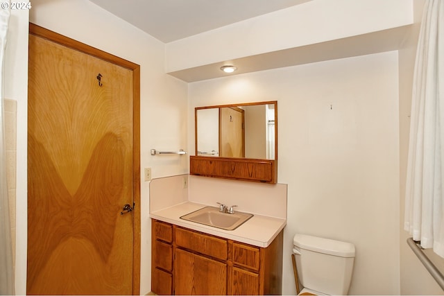 bathroom featuring vanity and toilet