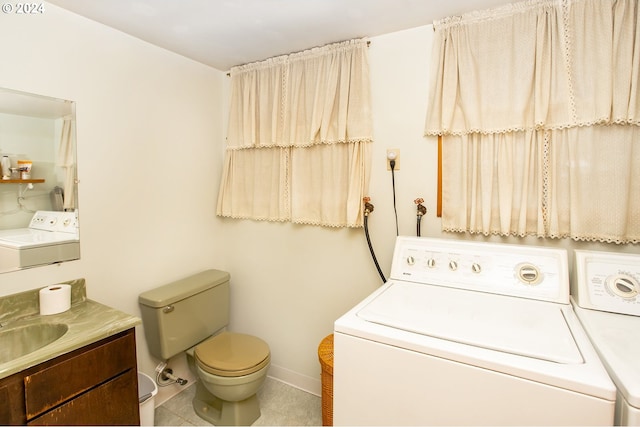 laundry area with washer and clothes dryer, sink, and tile patterned floors