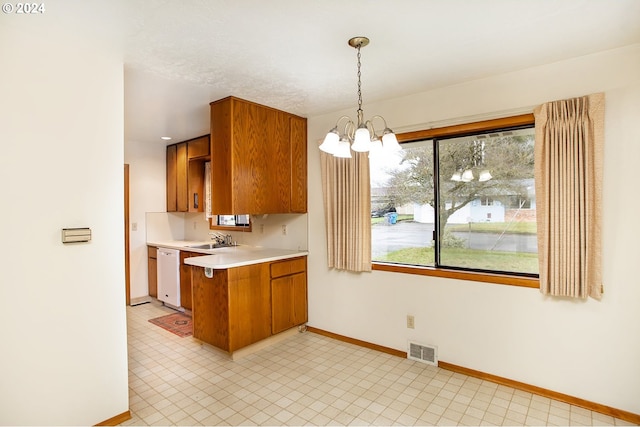 kitchen featuring kitchen peninsula, sink, decorative light fixtures, dishwasher, and a chandelier