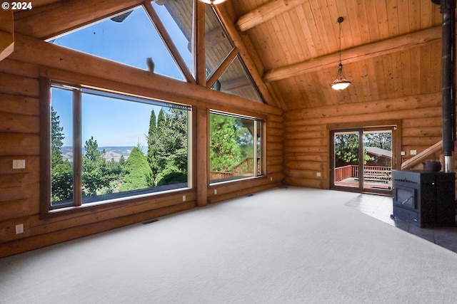 interior space featuring carpet floors, visible vents, wood ceiling, a wood stove, and beamed ceiling